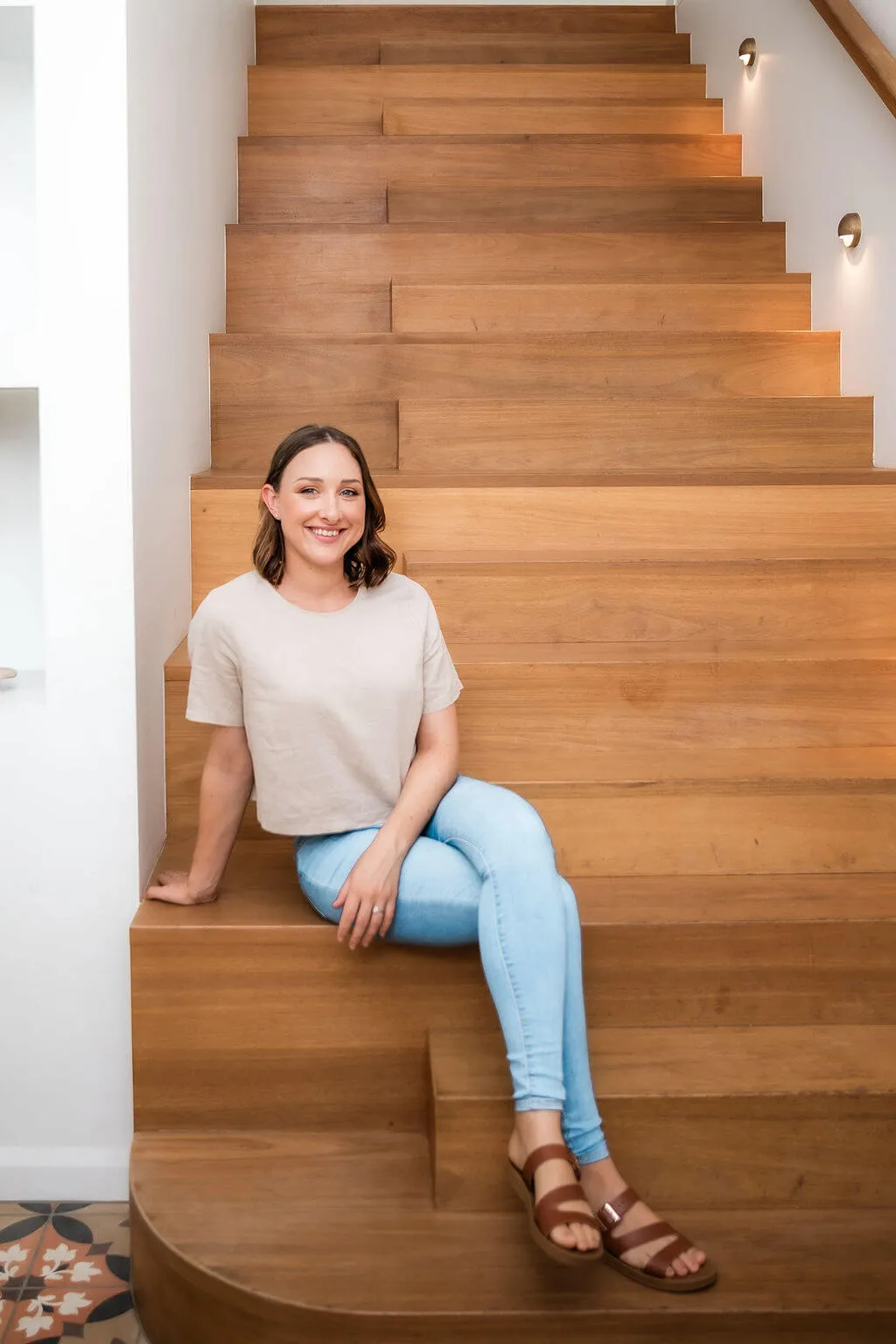 Maddy the owner of Dawner Creative sitting on a staircase (opens in a new tab)