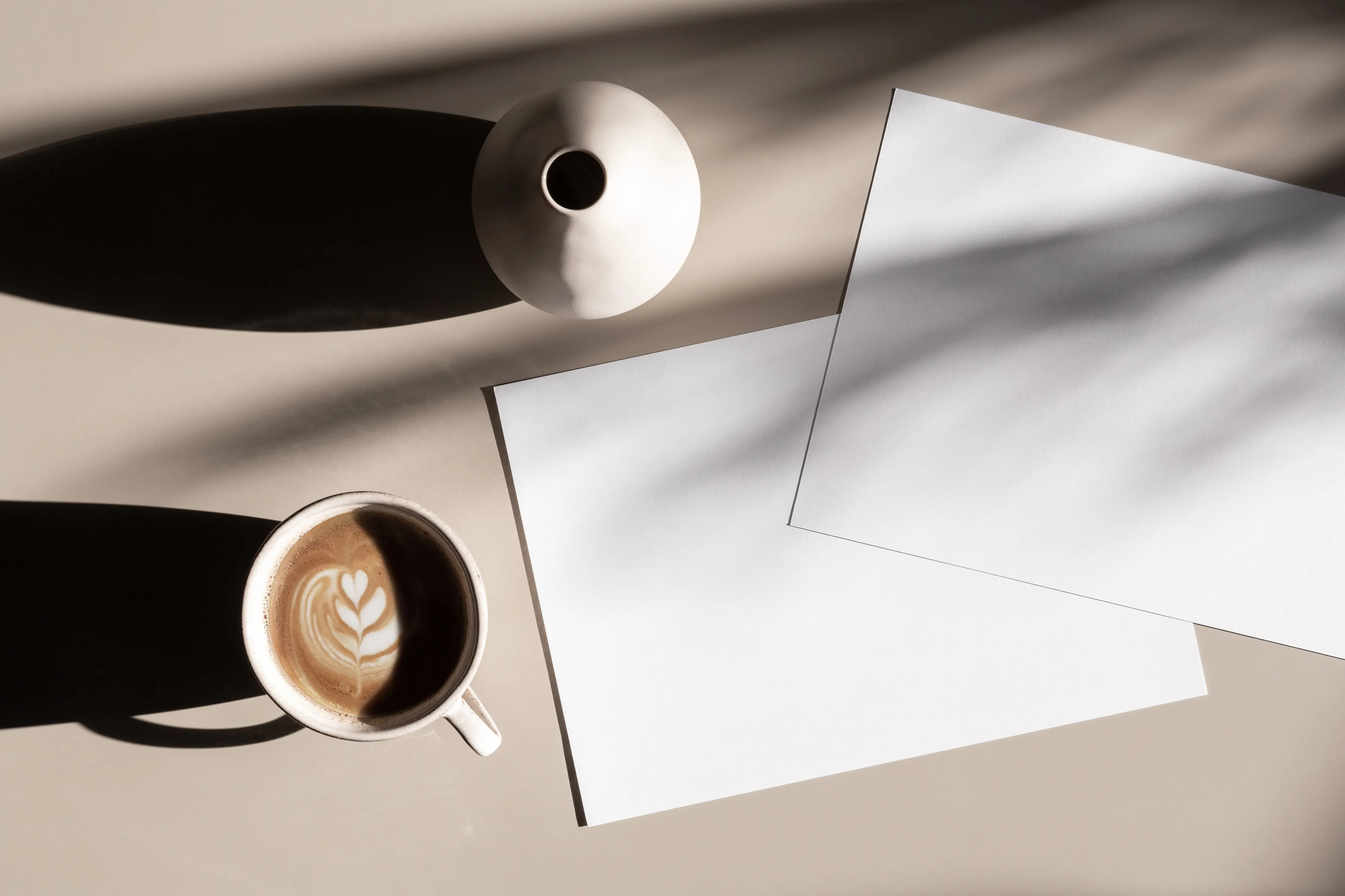 Vase and blank paper sitting on a desk